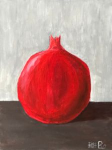 Red pomegranate in the grey room.