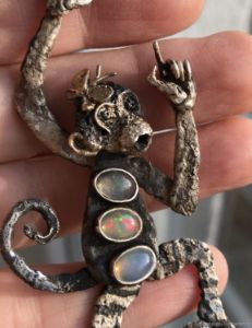 Monkey with butterfly pendant