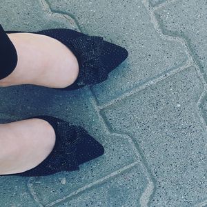 Feet in black high heels