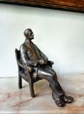Original sculpture of a seated man.