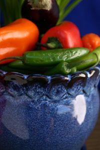 Cobalt blue pot of colorful chilies
