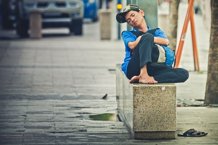 Vietnam, man lying on the street - Angelo Cordeschi