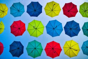 Colorful umbrellas on a blue sky in
