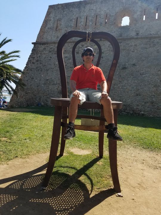 Young Man sitting on giant chair - telito - Photography, Childrens