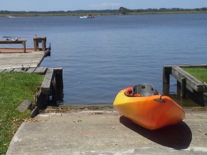 Orange kayak sitting by the bay