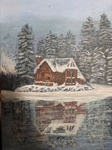 Snowy cottage by the lake