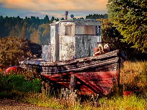 Abandoned Boat in Field at Sunrise